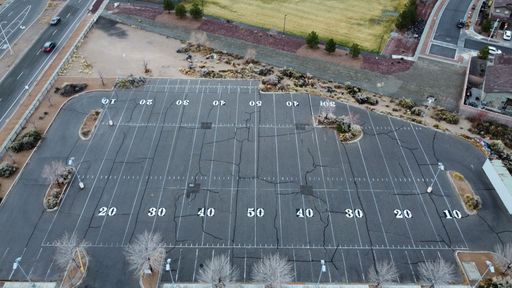 An aerial of a parking lot with football field markings