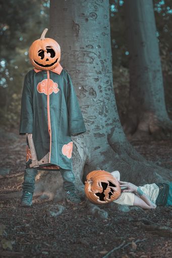 A vertical of scary teenagers dressed up for Halloween pretending to be in an axe murder scene
