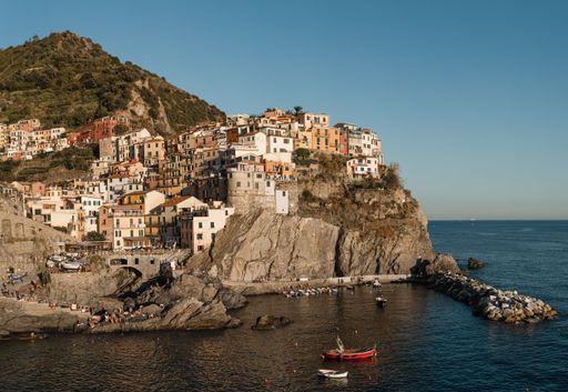 A natural view of a coastal village and cliff in Manarola, Cinque Terre, Italy