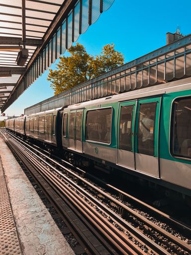 A vertical shot of a train station in Paris on a bright sunny day