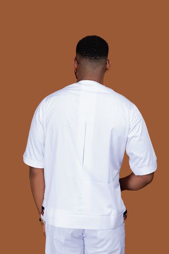 A back view of male wearing white clothes isolated in orange background