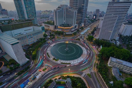 An aerial view of cityscape Jakarta surrounded by buildings with light trails