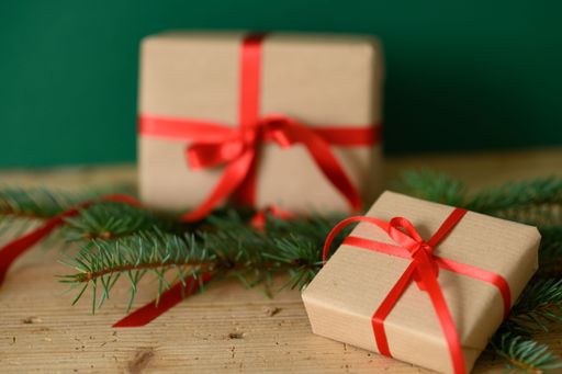 A closeup shot of Christmas presents against a green background