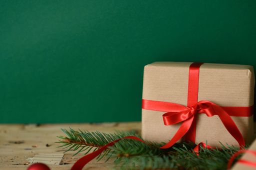 A closeup shot of Christmas presents against a green background