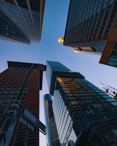 A low-angle shot of modern high buildings against the blue sky