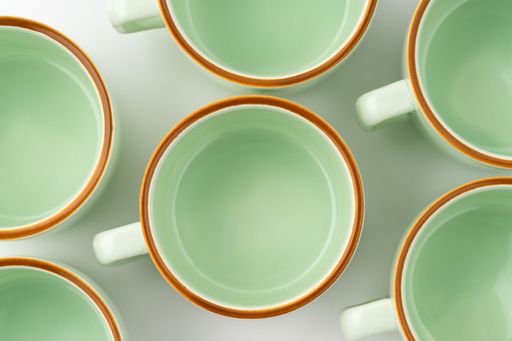 A closeup shot of a set of ceramic kitchen utensils on a white background.