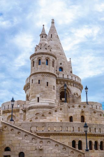 A vertical low-angle shot of the tower of Fisherman's bastion in Budapest, Hungary