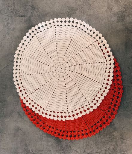 A top view of the embroidered red and white plate cloth