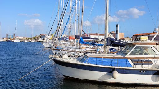 Yachts and other vessels moored at a marina on the Mediterranean coast of Italy - in Carloforte, Sardinia.