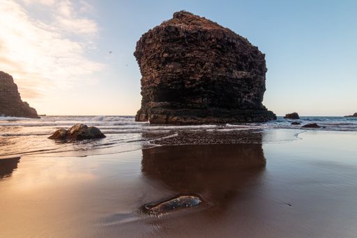 A closeup of huge rock formations in the sea