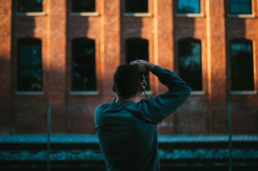 A man from behind taking a picture of architecture