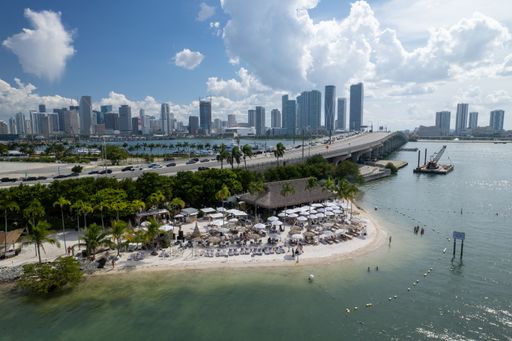 An aerial view of the Miami city skyline at the waterfront with the Joia beach