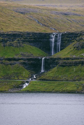 a vertical shot of Fossa Waterfall in the Faroe Islands