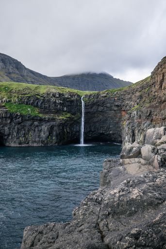 A vertical shot of the Fossa waterfall in the Faroe Islands
