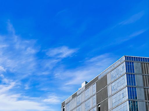 A low angle of the top of building against a blue sky
