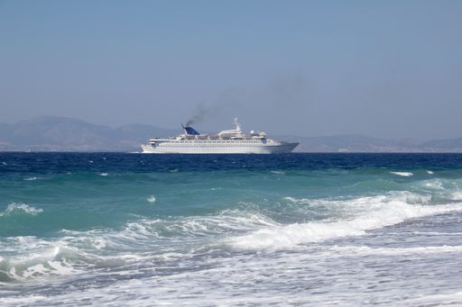 A ship sailing in the sea not far away from the coast