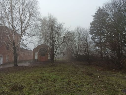 An old abandoned stone house in a mysterious foggy park
