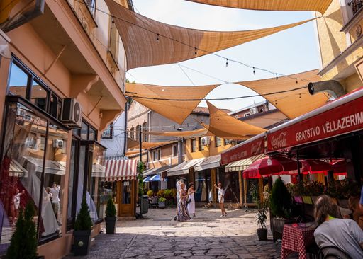 A group of people shopping at the Old Bazaar market in Skopje with traditional buildings in Macedonia