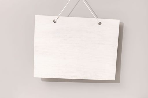 Blank white bleached wooden sign hanging on beige background. Mock up template