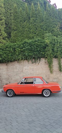 A vertical shot of a retro red car in the street. rothenburg ob der tauber, Germany