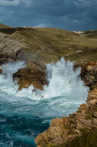 A beautiful scenery of rocky cliffs by the sea under a cloudy sky