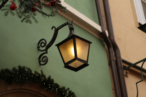 A low angle shot of a lamp hanging on a wall
