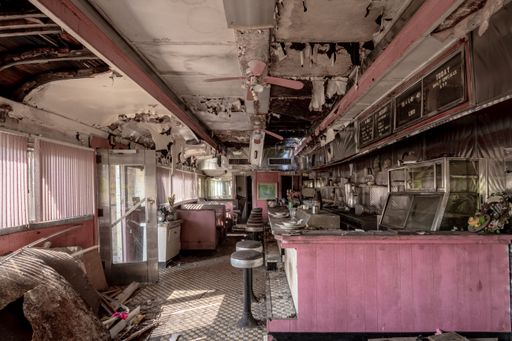 A cafe with dilapidated walls and roof