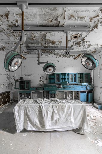 A vertical shot of a dilapidated hospital