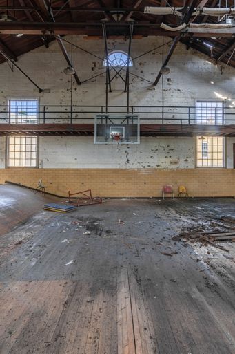 A vertical shot of a dilapidated basketball court