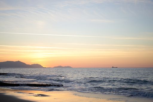 A beautiful view of the coast with a clear skyline at sunset