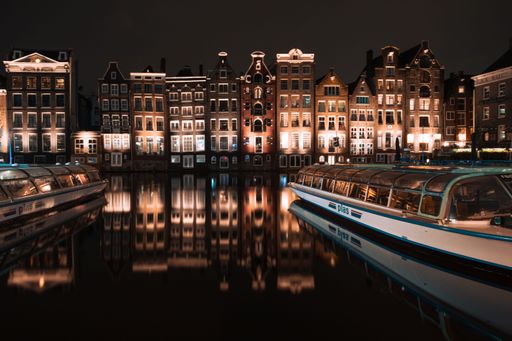 The beautiful old buildings of Amsterdam with the canals in front of them near the Central Station