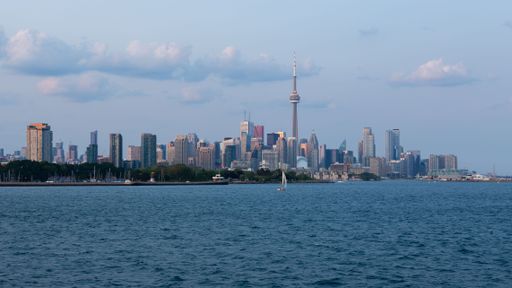An aerial view of cityscape Toronto surrounded by buildings and water