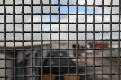 metal grating on the side of railway footbridge