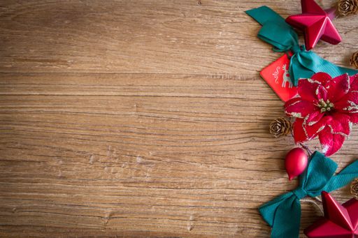 A top view of Christmas ornaments on a wooden surface with a copy space