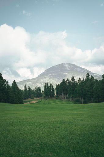 A beautiful shot of a golfing course in a field in Invermere, British Columbia, Canada
