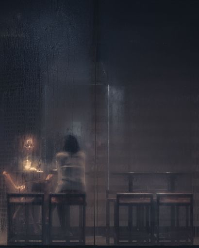 A vertical shot of two female friend behind a window glass