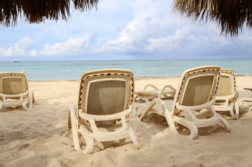 A view of the lounge chairs on the beach during daylight