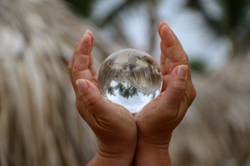 An abstract closeup focus shot of a woman holding a glass ball