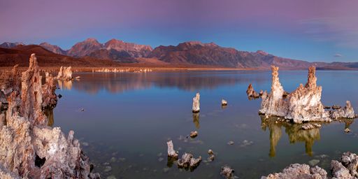 A panoramic shot of the Mono Lake surrounded with mountains during the sunset in California, USA
