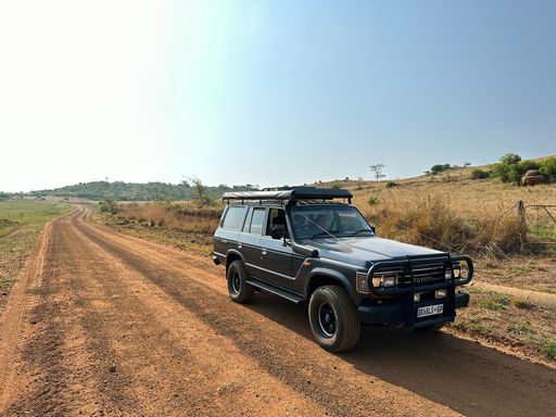 A Toyota Land Cruiser on the dirt road in the deserted valley