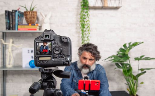 A closeup shot of a DSLR camera recording a video blog