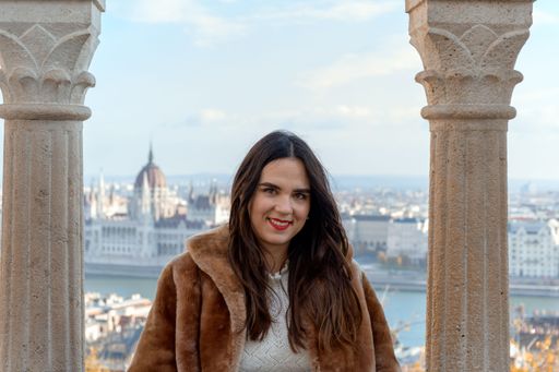 A shallow focus shot of a young beautiful female looking at the camera in Budapest, Hungary