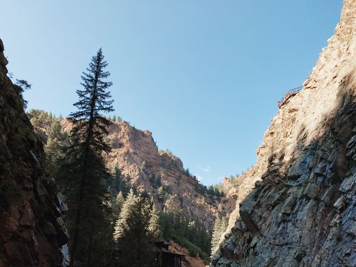 The low-angle view of rocky mountains under the blue sky on a sunny day in Colorado