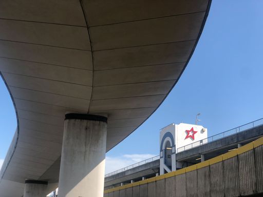 A view from under a stone bridge with a cinema in the distance in Brighton, UK