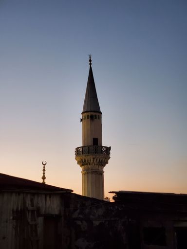 A vertical low angle shot of a Minaret of Mosque during sunset in Istanbul