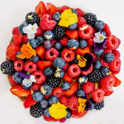 A top view of different varieties of berries isolated on a white background