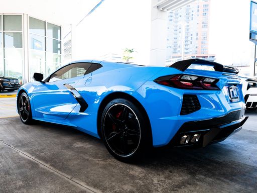 A bright blue Chevrolet Corvette sports car parked outdoors