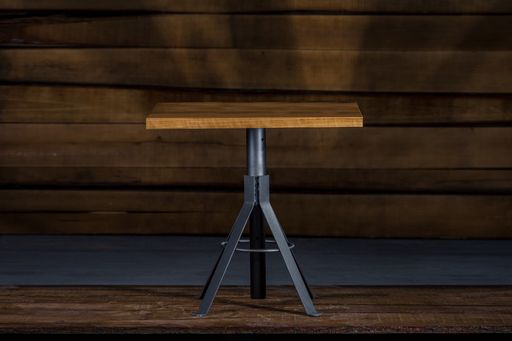 An outdoor coffee table with metal legs in a studio