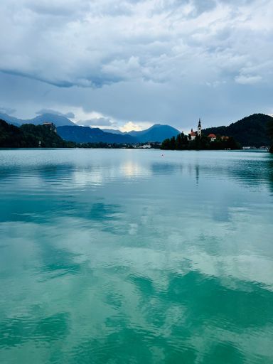 A vertical shot of the scenic Lake Bled under the blue sky in Slovenia