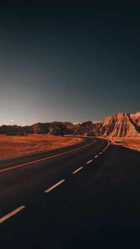 A vertical shot of an empty road in Badlands National Park, South Dakota.